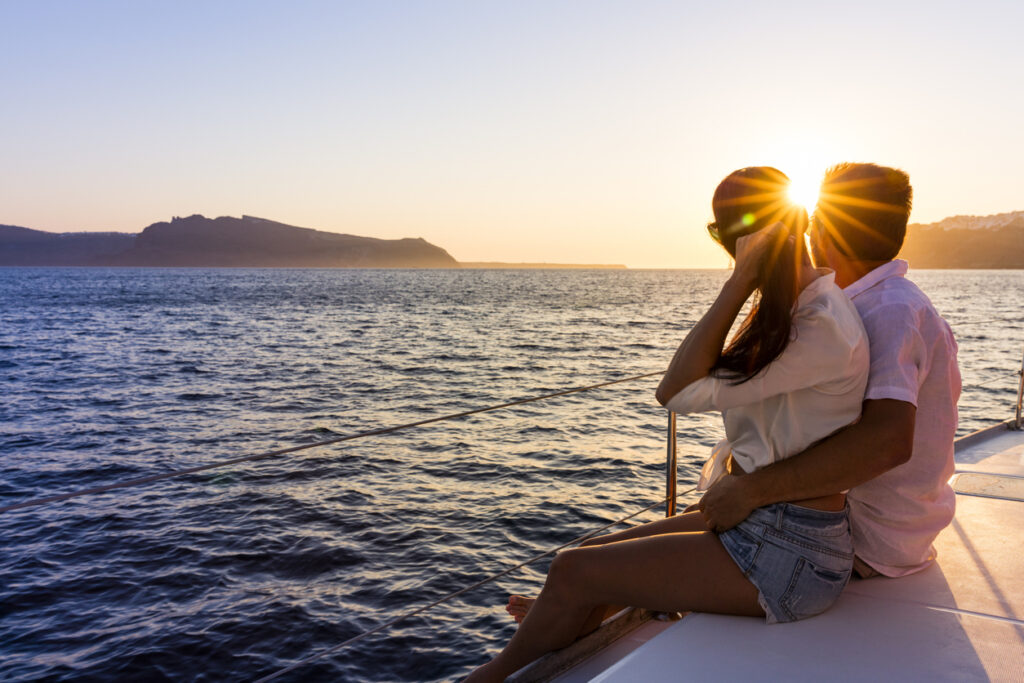 Romantic couple on yacht at sunset in Greece